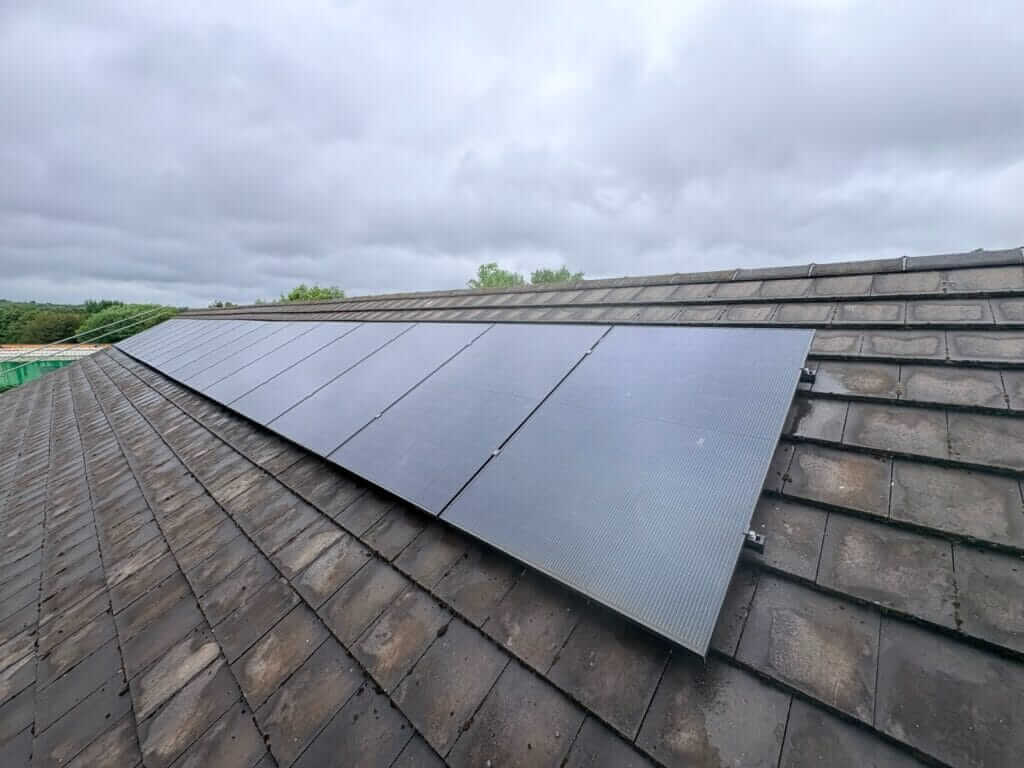 Black solar panels installed on a tiled roof