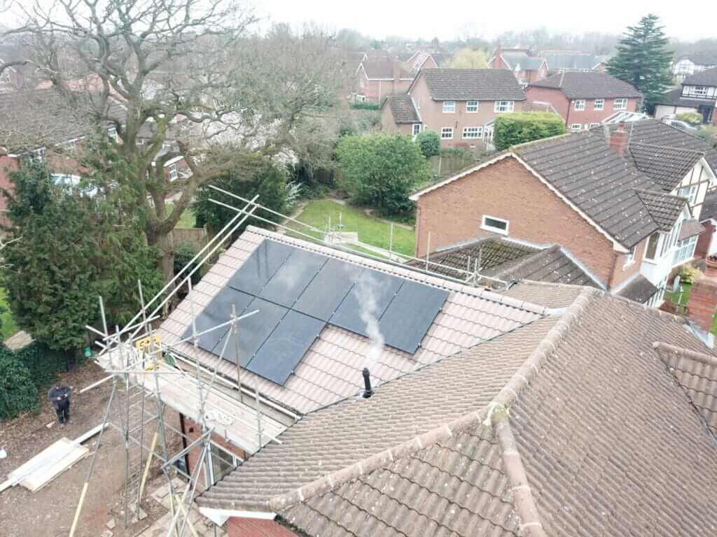 Solar panels being installed on a house roof with scaffolding