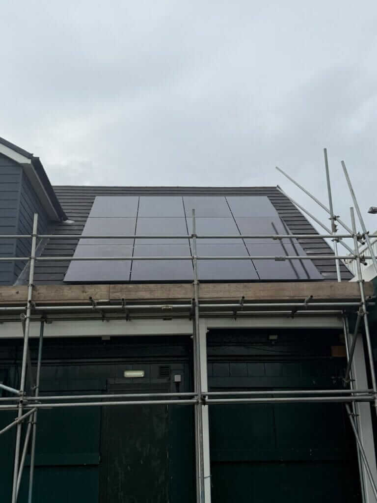 Solar panels fitted to a roof with scaffolding in place