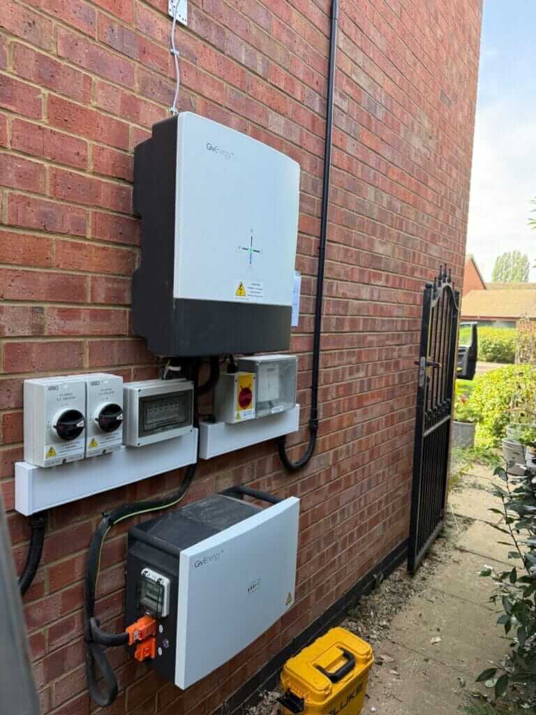 Solar inverter, isolators and battery on a house wall