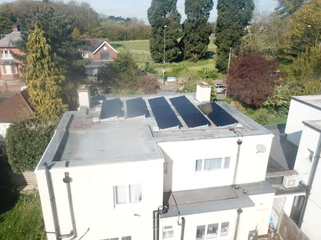 Solar panels installed on a rendered house roof