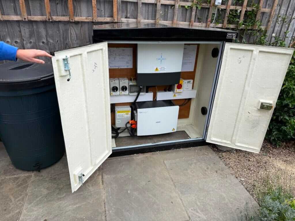 Solar inverter and battery housed in an outdoor cabinet