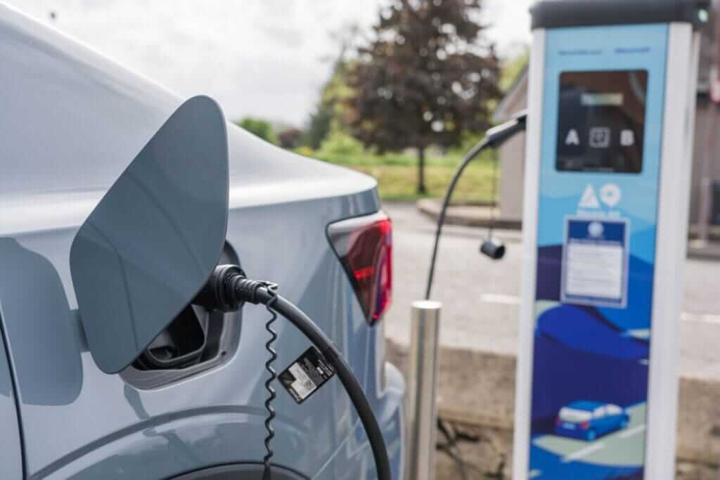 Electric car plugged into a dual-socket charging point