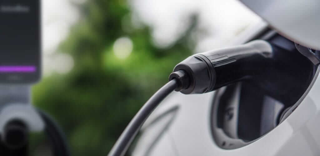 Charging cable plugged into the charge port of an electric car