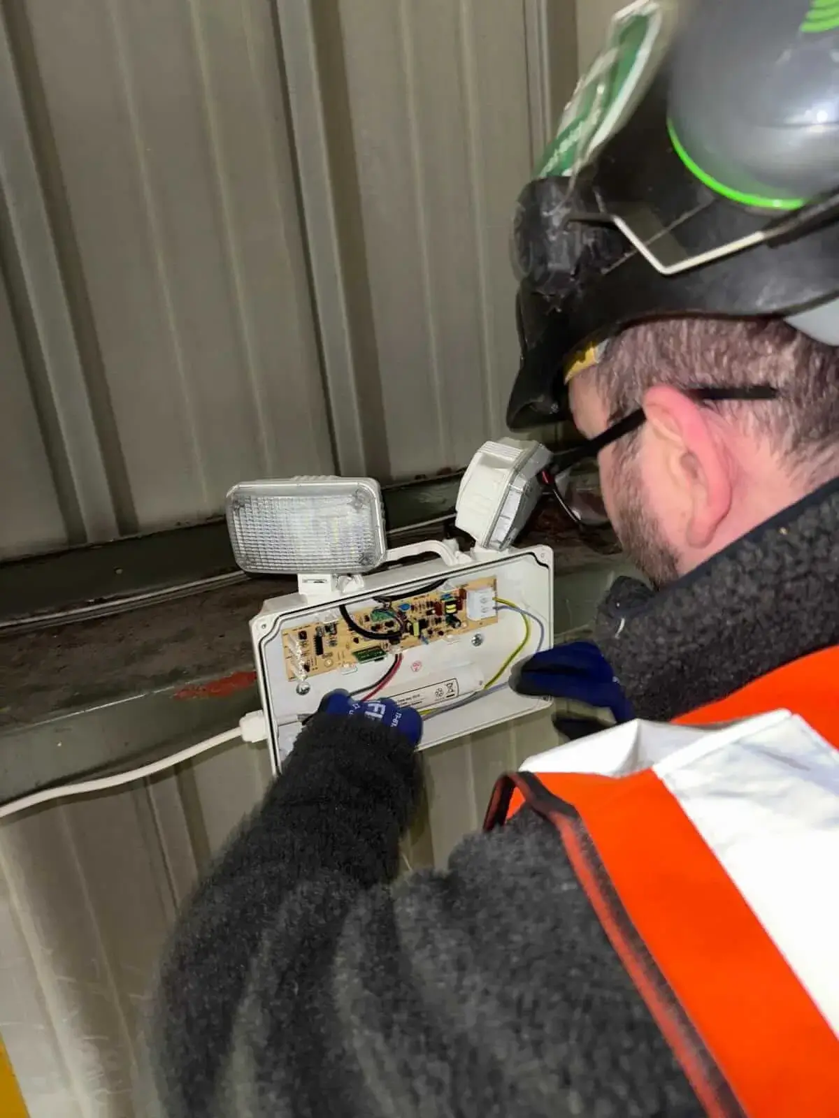 Ashware Electrical engineer installing commercial emergency lighting