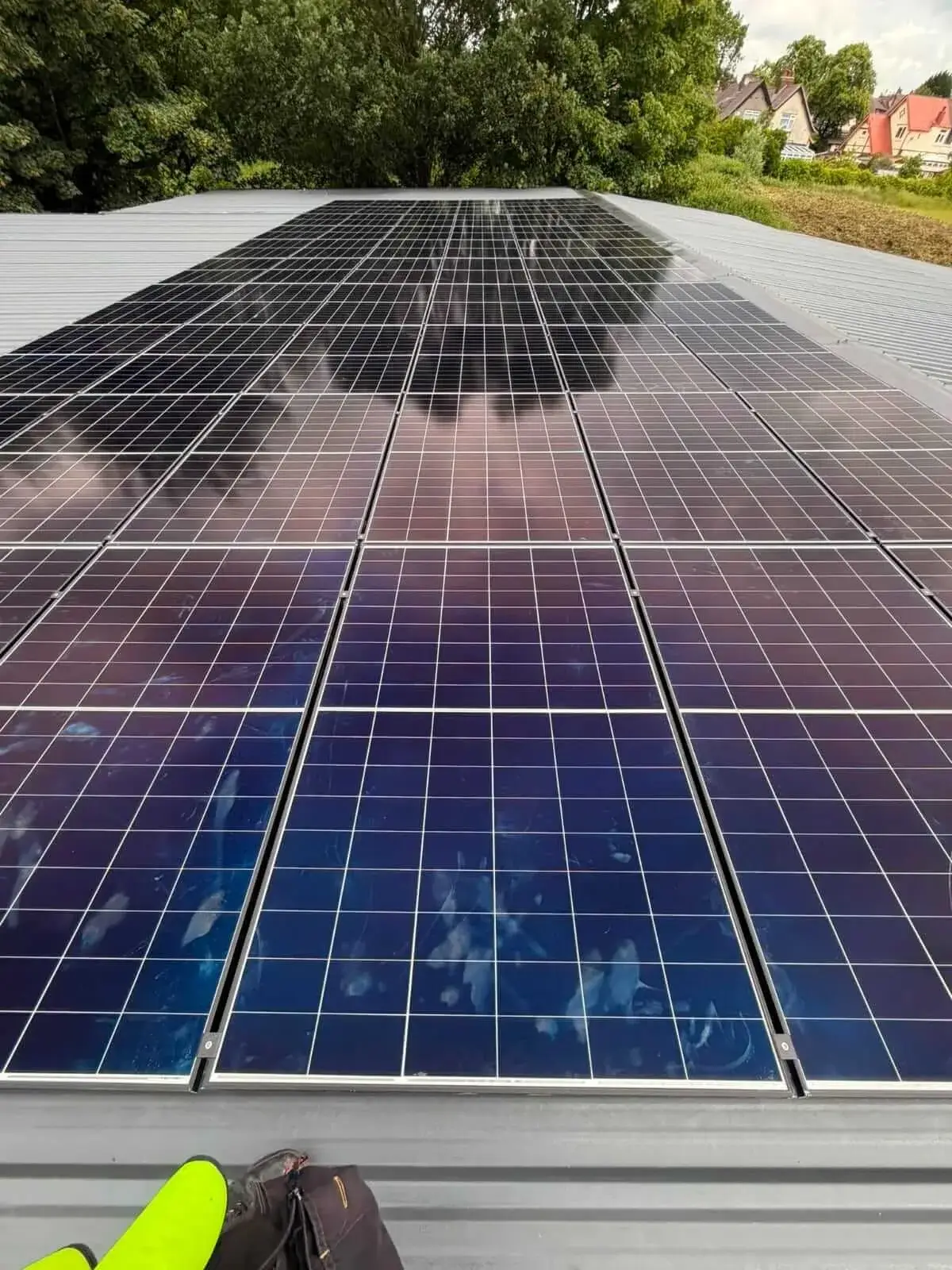 Solar PV panels mounted on a flat roof, installed by Ashware Electrical in Staffordshire
