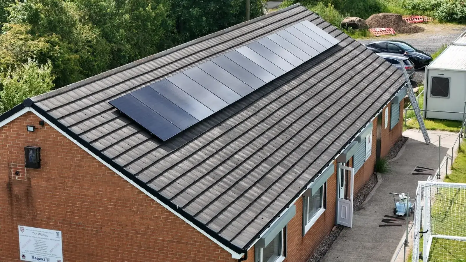 Aerial view of a solar PV array on a clubhouse roof installed by Ashware Electrical